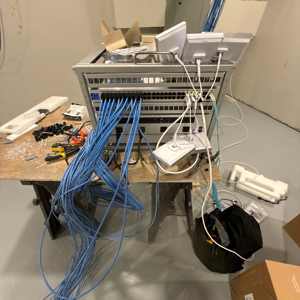 Network rack with blue structured cabling and equipment during installation